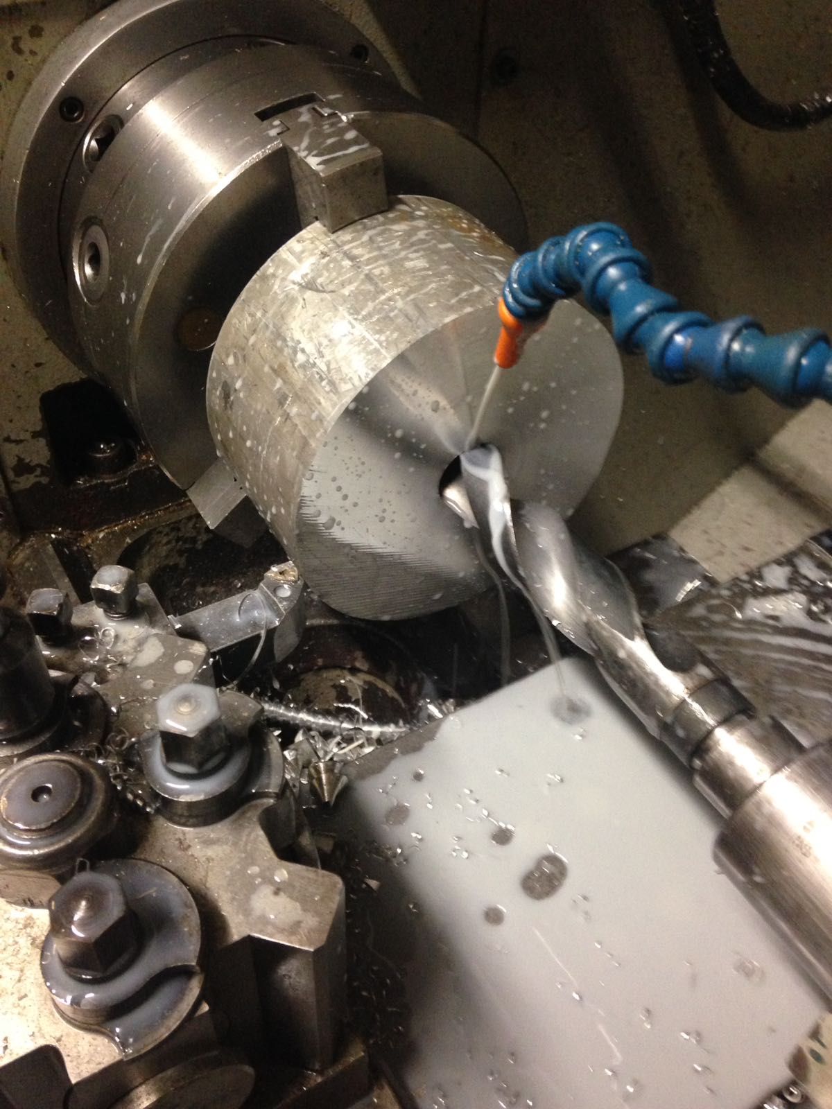 A picture of our CNC drill in action. In this photo it is drilling stainless steel